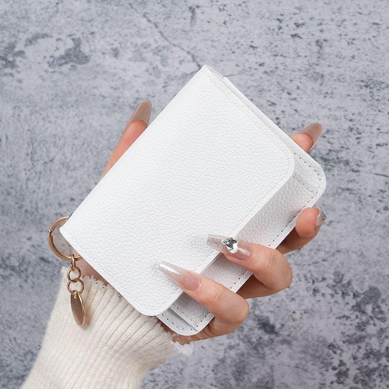 White short wallet held in one hand