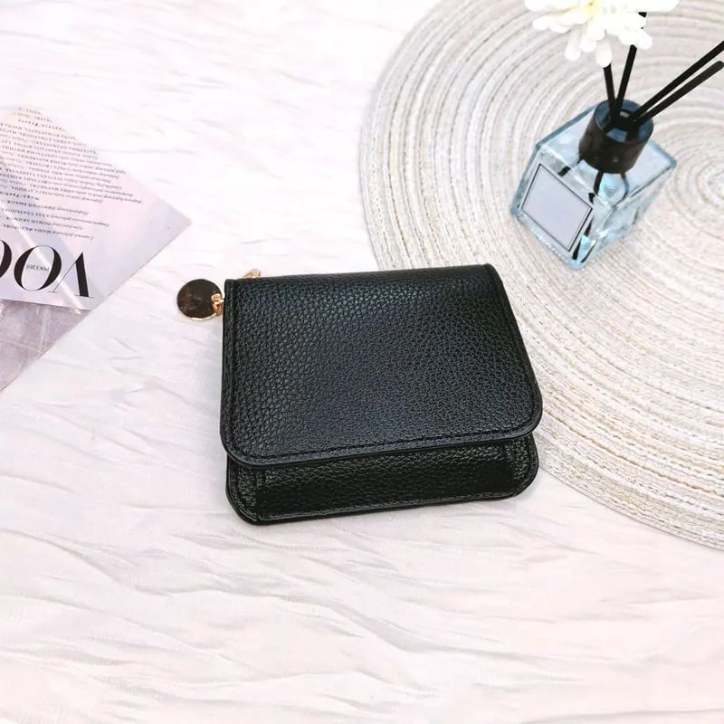 Black wallet styled on a clean surface